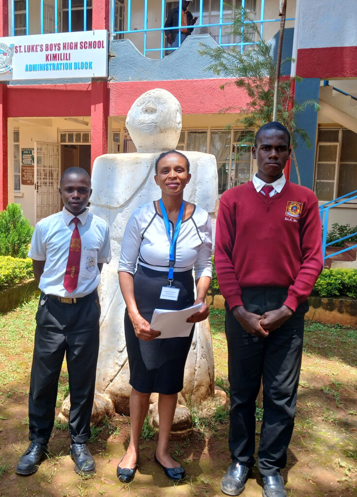 Liaison officer with two students